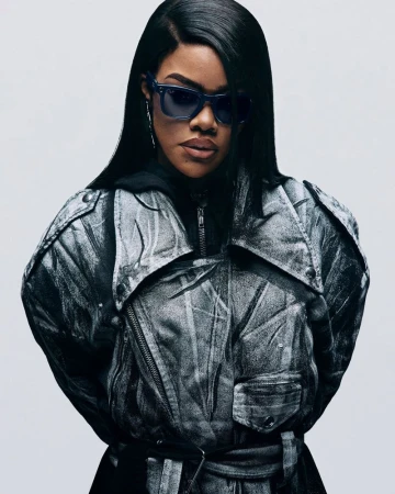 Teyana Taylor wearing sunglasses and a patterned jacket against a plain white background for Ray-Ban