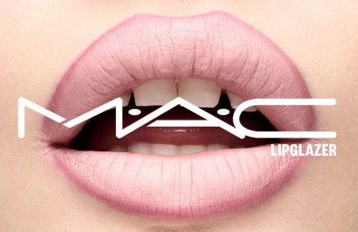 Extreme close-up of glossy pink lips with white teeth visible and bold MAC Lipglazer logo overlay