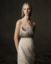 Model posing in an intricately beaded halterneck gown with ombre detailing for the Phan Huy Couture fall winter campaign