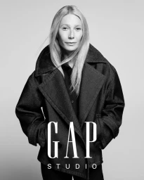 Gwyneth Paltrow wearing an oversized dark coat against a plain studio background for the GapStudio campaign