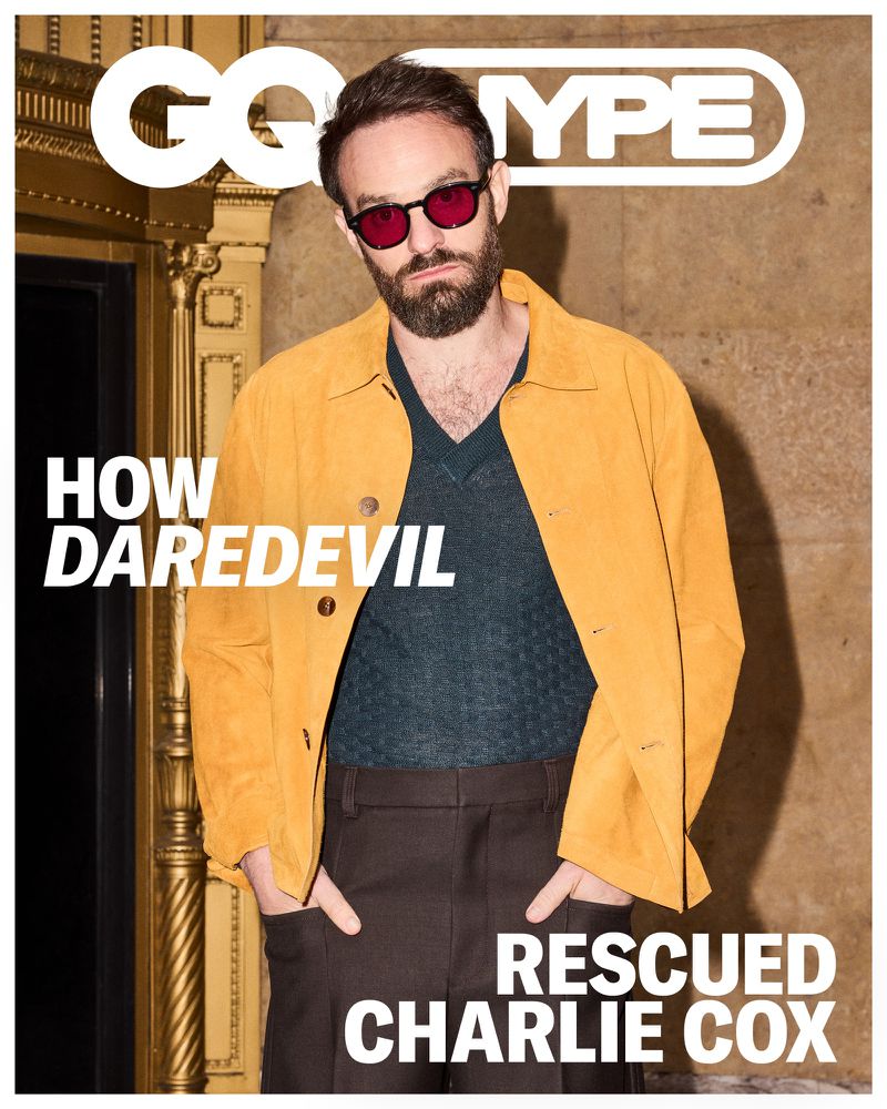 Magazine cover featuring a man in a yellow jacket and sunglasses standing in front of a neutral background with 'GQ TYPE' text.