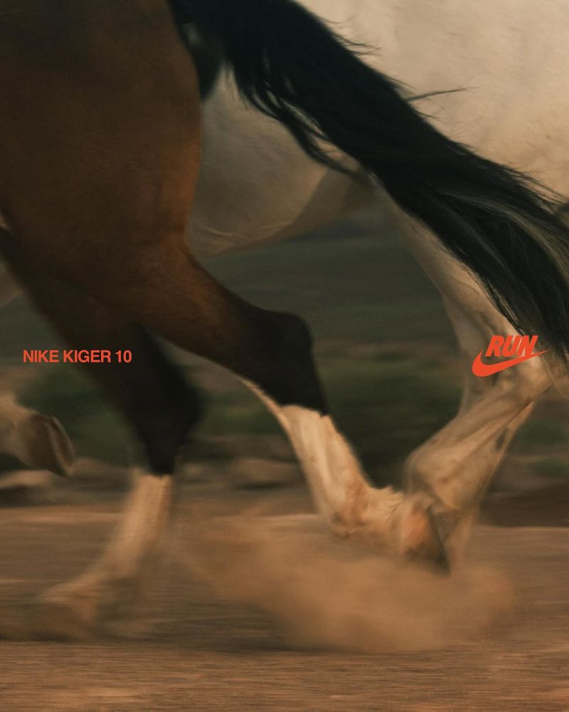 Motion blur of a horse running across a dirt field, with a Nike logo and the words "Nike Kiger 10" and "Run" visible.