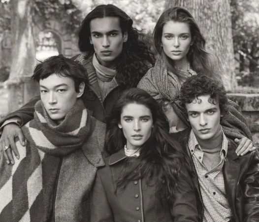 Group portrait of five models wearing autumn knitwear and coats in a black and white outdoor scene for Zara.