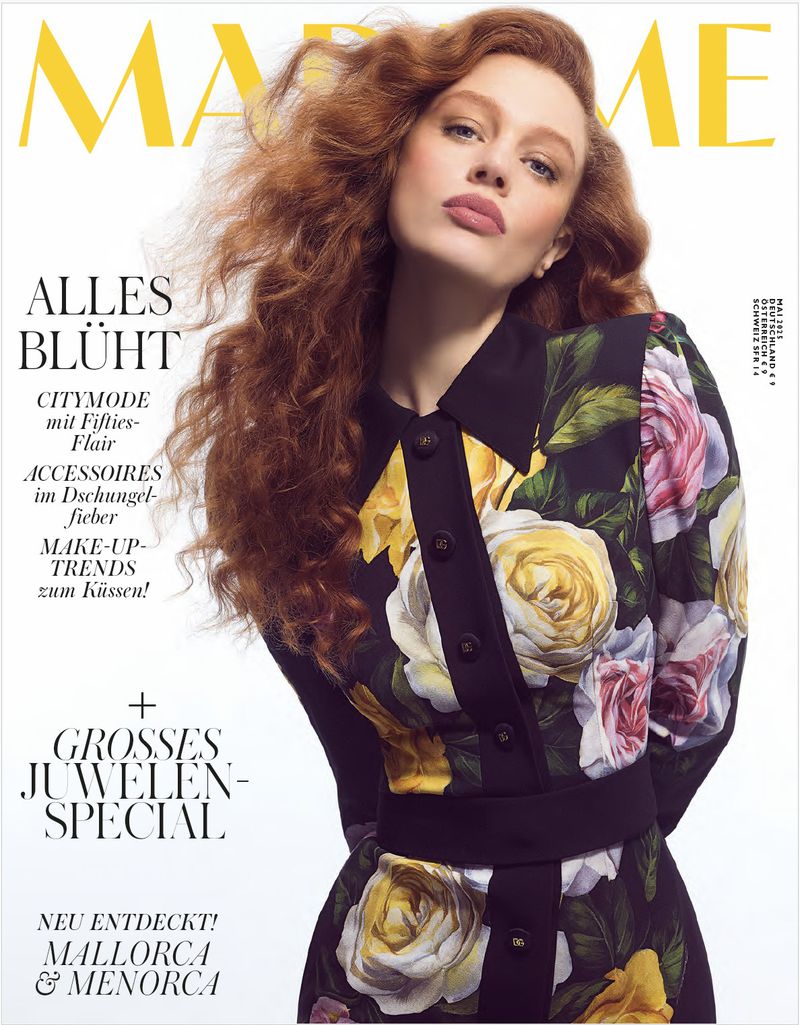 Magazine cover featuring a red-haired model wearing a floral dress, with masthead and cover text in yellow, against a white backdrop.