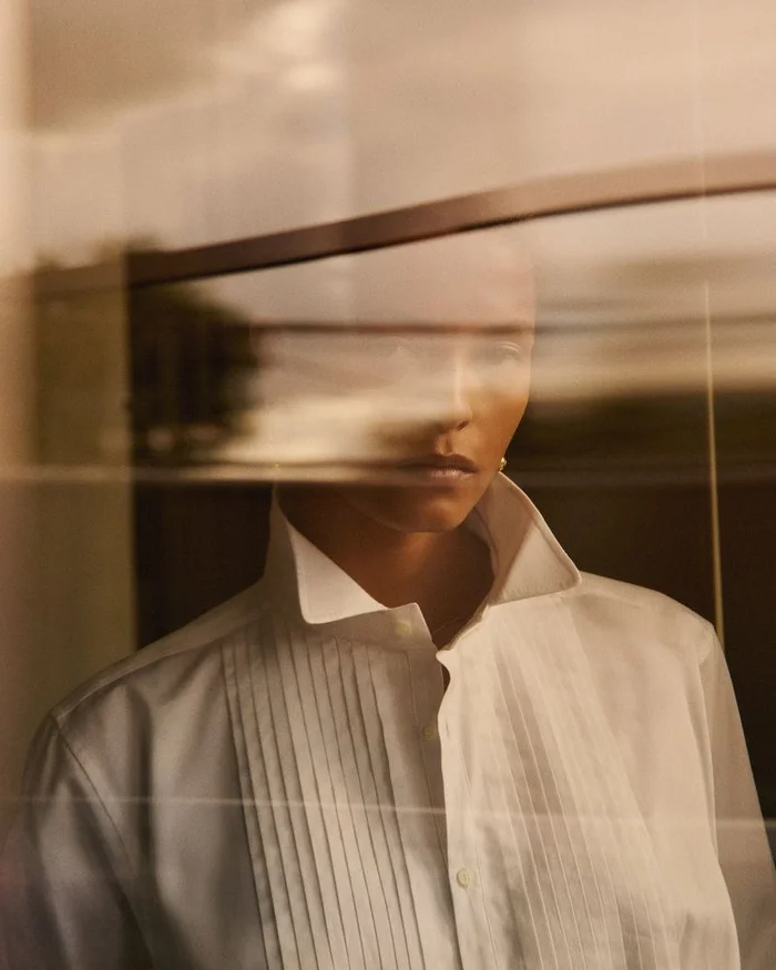 Model Laiza de Moura in a white collared shirt shot through a glass reflection for Alex Eagle shot by Paul Scala.