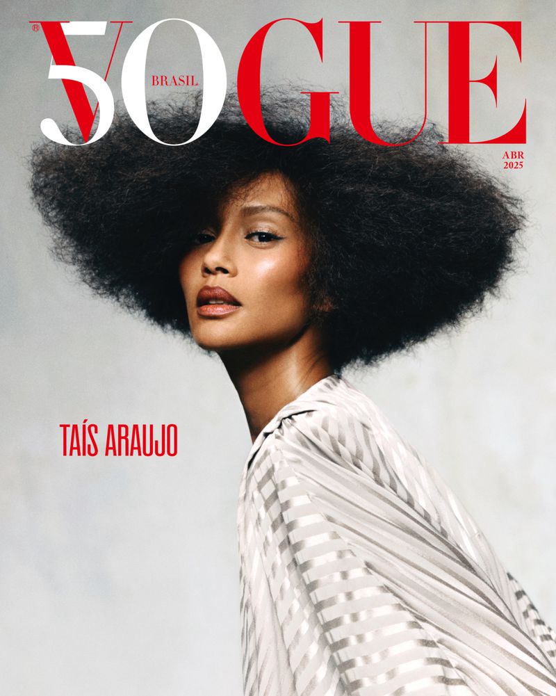 Vogue Brasil cover featuring Taís Araujo with large afro, wearing a vertically striped top, against a grey background.