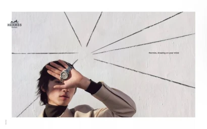 Model Hidetatsu Takeuchi holding a silver wristwatch against his face for Hermes Fall Winter 2025 campaign