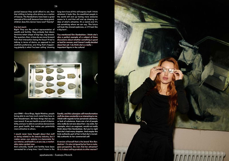 Magazine spread featuring a red-haired woman with silver glasses sitting in front of an abstract car painting, alongside an article.