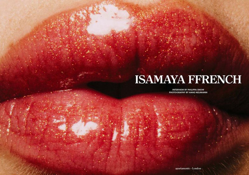 Close-up of a woman's lips, featuring red lipstick with gold glitter, set against a fair skin tone and a neutral background.