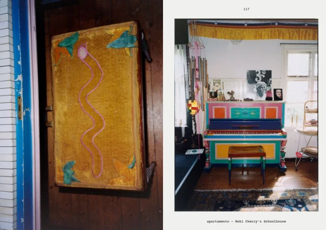 Vintage photograph of a brightly painted upright piano indoors with colorful decor and antique furniture, offering a glimpse into an eclectic, artistic home.