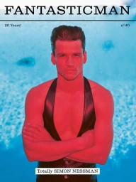 Model Simon Nessman with arms crossed wearing a leather vest against a blue water background for Fantastic Man magazine.