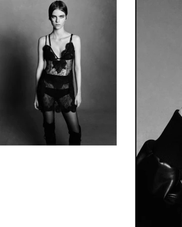 A woman poses in a black lace slip dress and thigh-high boots against a grey backdrop in a studio fashion shot.