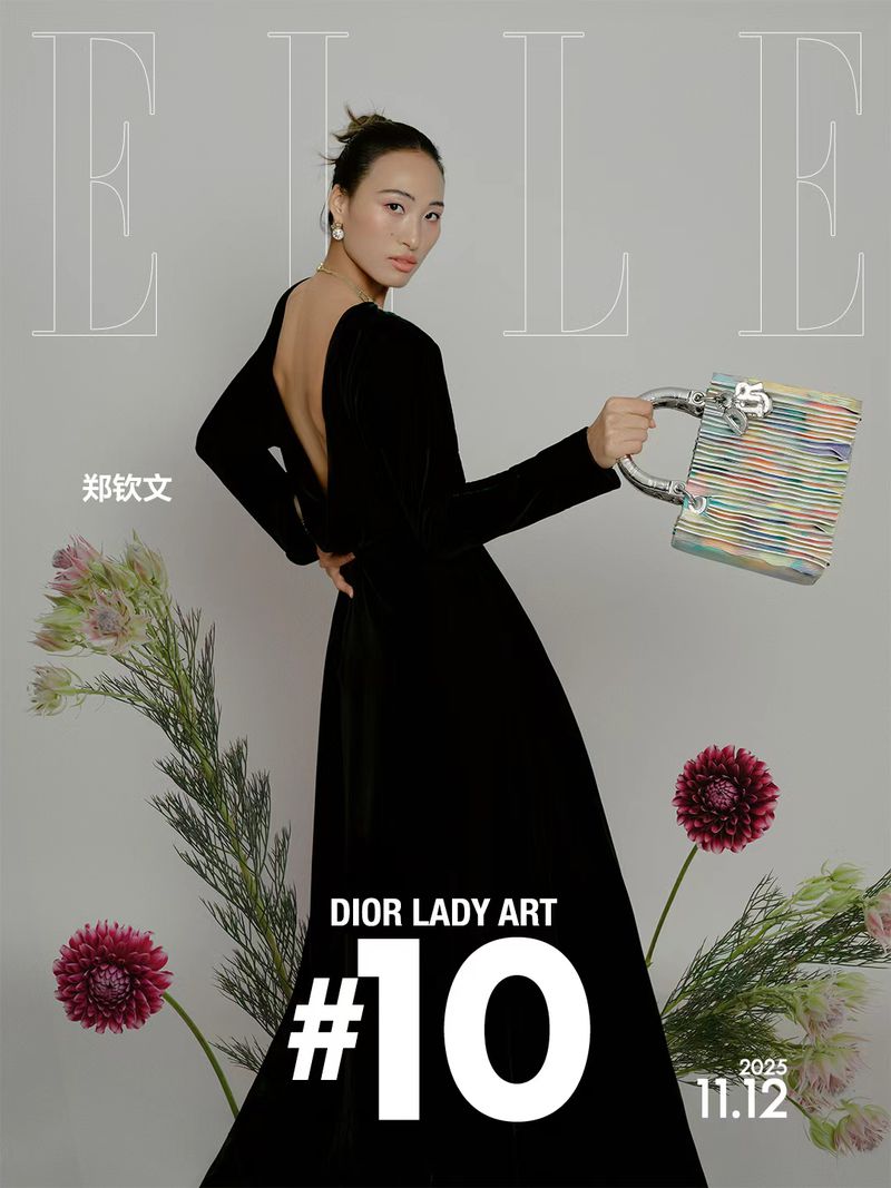 Elegant Asian woman poses in black gown holding colorful purse for ELLE magazine cover, featuring flowers, and 'DIOR LADY ART'.