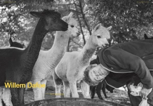 Black and white portrait of actor Willem Dafoe bending upside down next to three alpacas outdoors.