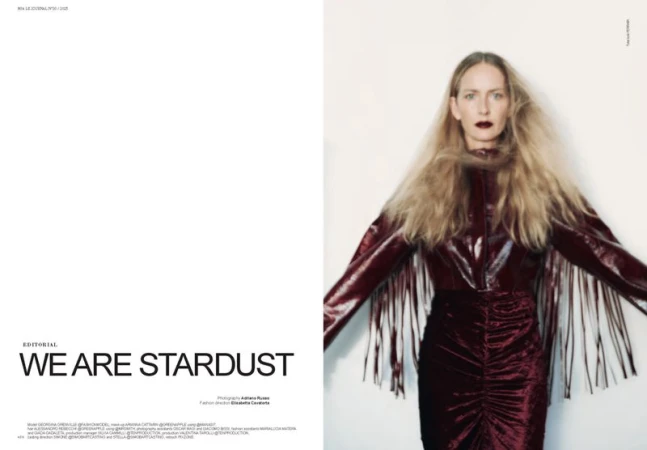 Model Georgina Grenville wearing a burgundy fringed jacket and velvet skirt against a white seamless backdrop.