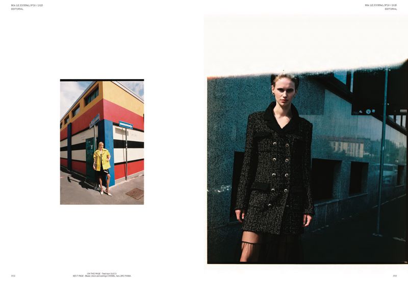 Editorial shot of a woman in a tweed jacket dress against a building, with a second woman in yellow in the background.