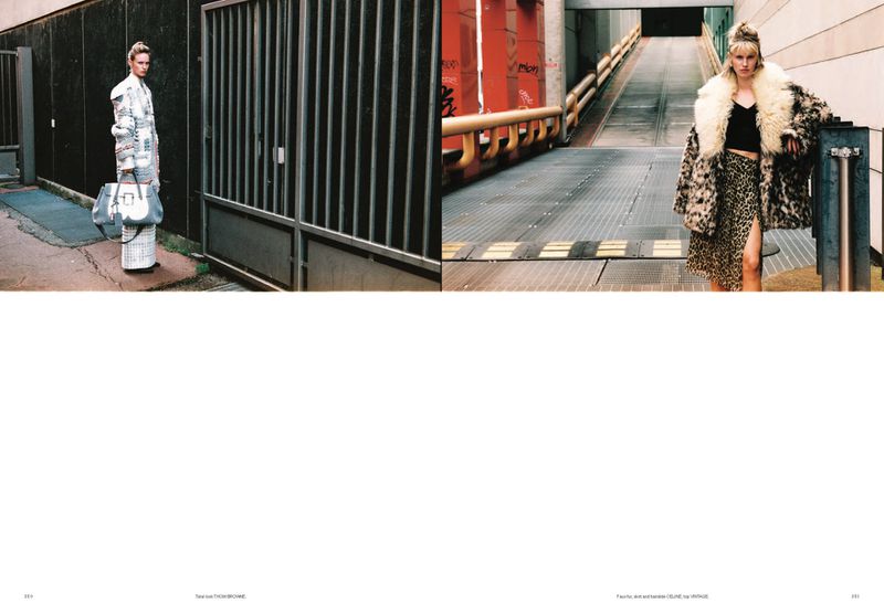 Fashion shoot with two women in patterned outfits. One wears a patterned jacket and carries a bag, the other in leopard print in a tunnel.