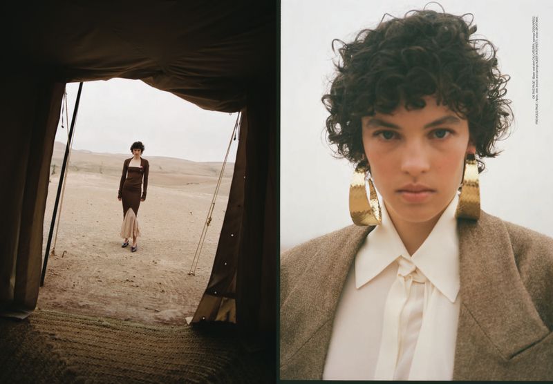 Fashion shot: woman in brown dress, shot through tent opening to desert landscape; close-up shows gold earrings, white blouse, and brown jacket.