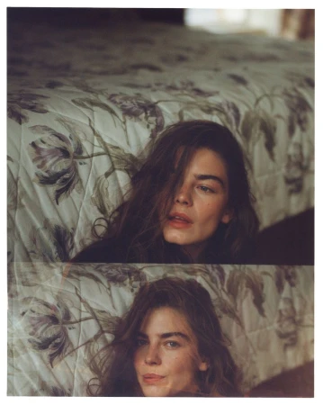 Model Merlijne Schorren pictured indoors against a floral patterned bedspread for Vogue Netherlands Scotland Yarn editorial