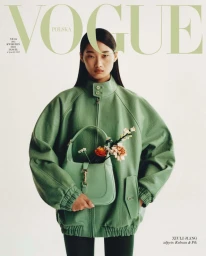 Model Xiuli Jiang in a green jacket holding a matching handbag with flowers for Vogue Polska