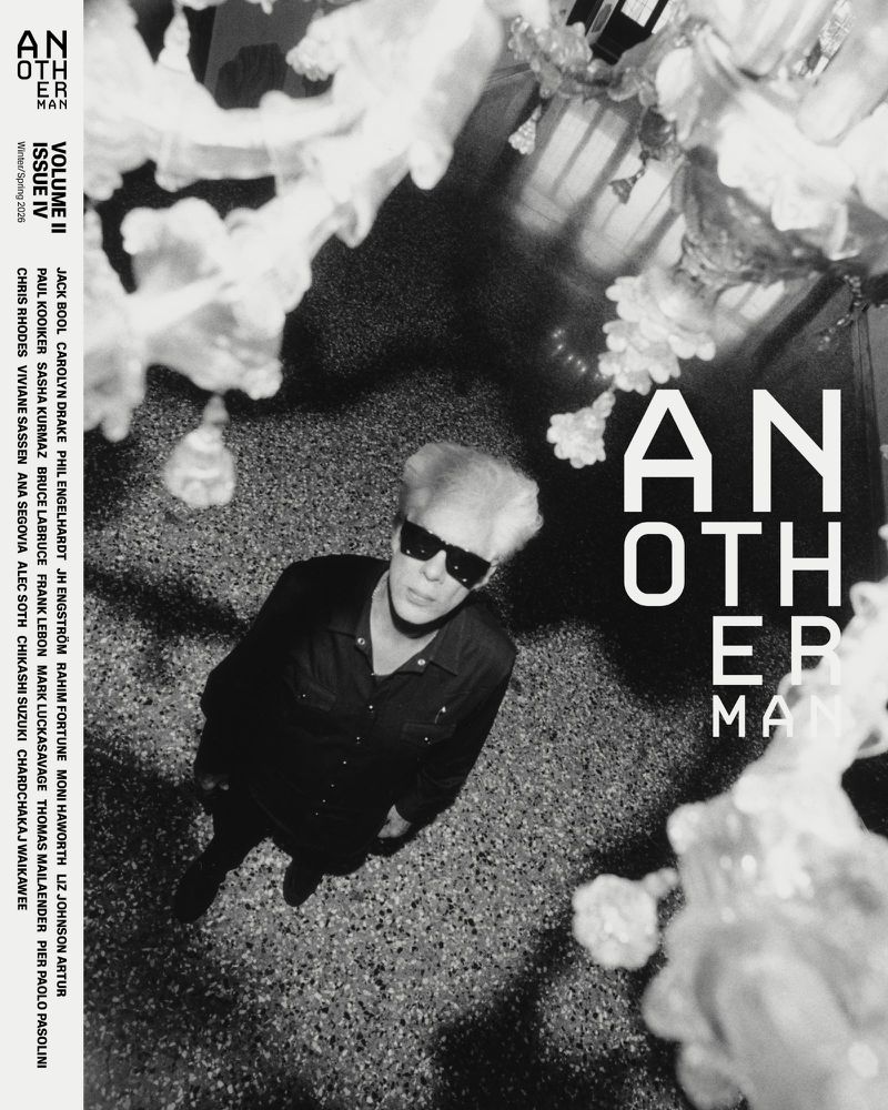 Jim Jarmusch wearing sunglasses and a dark button-down shirt viewed from above against a textured stone floor, AnOther Man magazine cover.