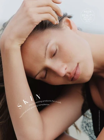 Close-up shot of a woman with her eyes closed, hand resting on her head, promoting skincare for a soft and glowing complexion.