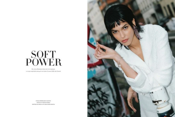 Model Iza Dantas wearing a white bouclé jacket next to bold Soft Power title text in a Harper's Bazaar Brazil editorial spread.