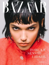 Model Iza Dantas with wet-look micro bangs and a textured coral jacket on the cover of Harper's Bazaar Brazil.