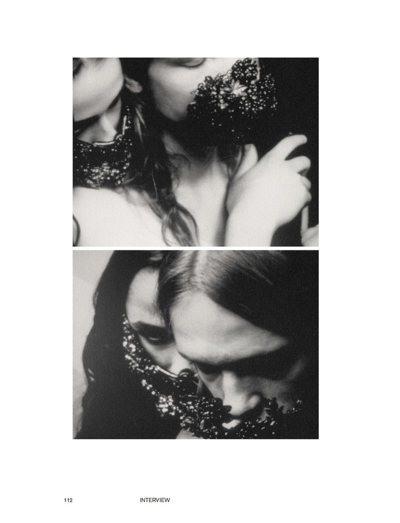 Black and white image showcases two fashionable women wearing beaded necklaces covering their faces in a studio setting. Editorial fashion.