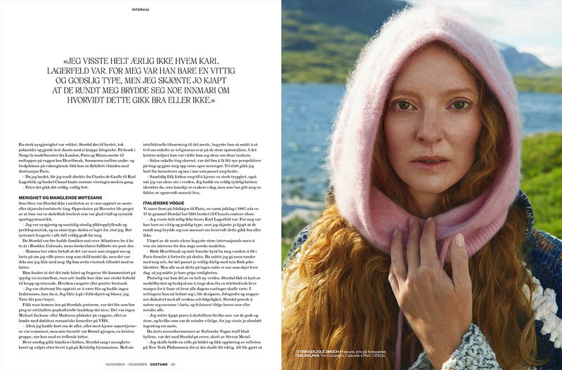 Close-up portrait of a redhead woman wearing a pink knit balaclava with a natural background, as seen in a magazine editorial.