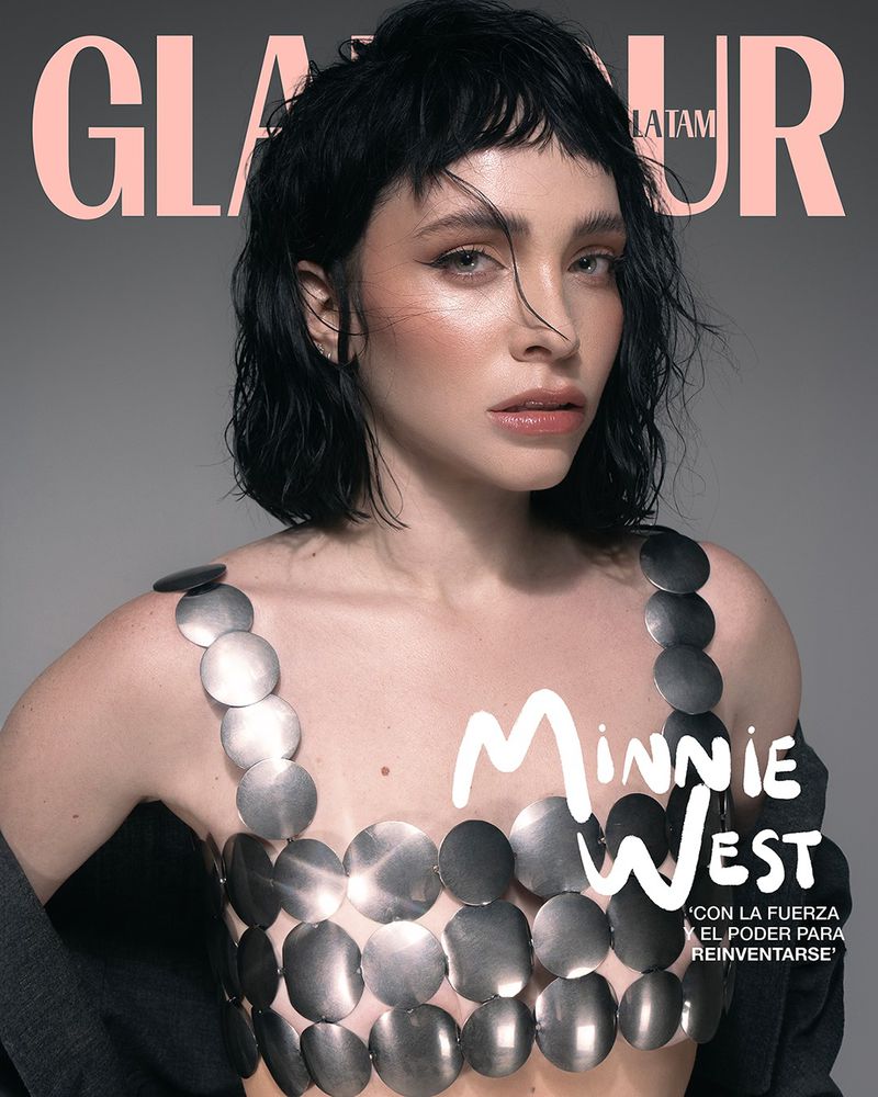 Glamour Latam magazine cover featuring a woman with short, dark hair wearing a silver disc top, against a neutral grey background.