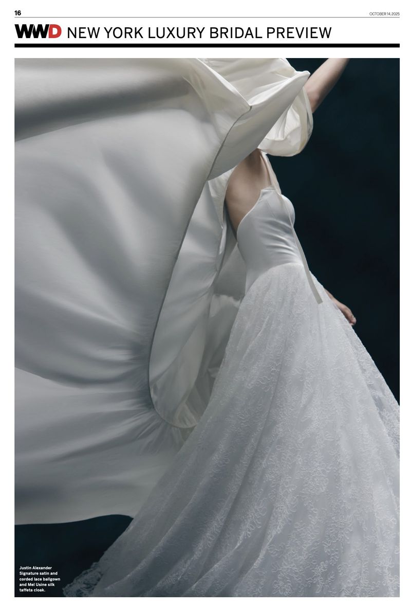Editorial fashion shot of a woman in a white wedding dress with a flowing cape on a dark background for WWD New York Bridal.