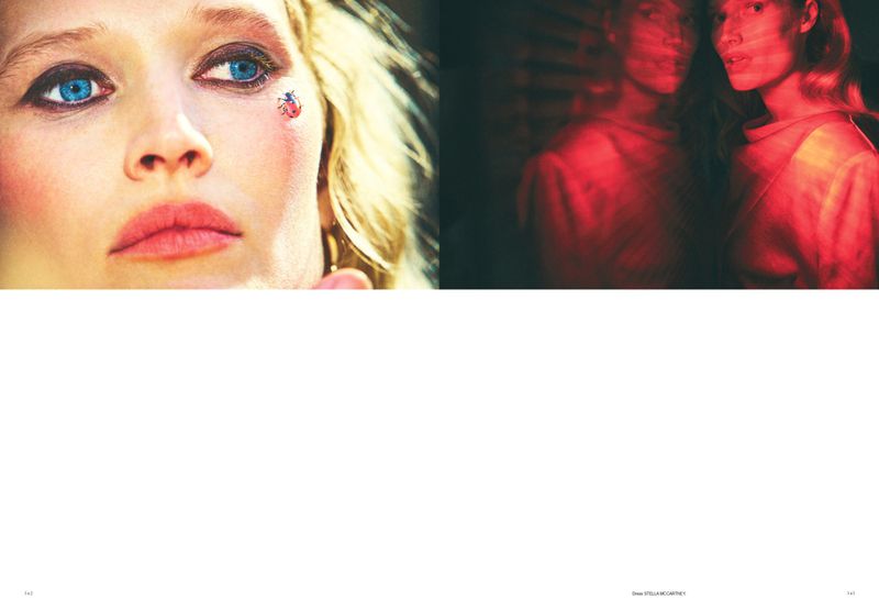 Fashion photo featuring a blonde woman's face close-up with light skin, blue eyes, a ladybug sticker, plus a blurred face in red lighting.