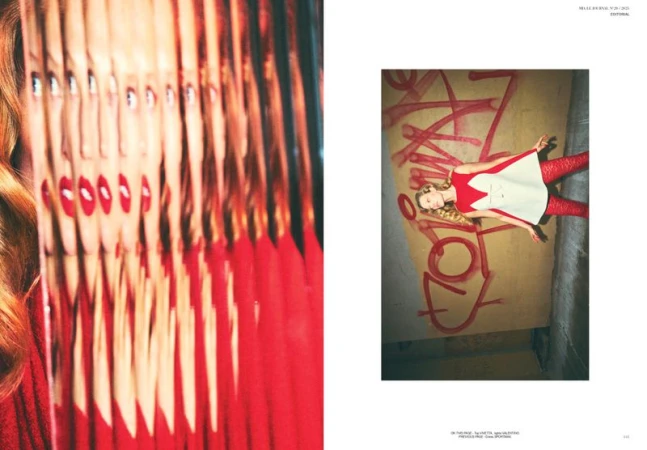 Editorial fashion shot featuring an adult female model in a red and white dress lying next to graffiti. Close up shot of a woman's face with multiple reflections.