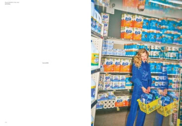 Model Toni Garrn holding yellow shopping baskets in grocery aisle for Mia Le Journal editorial