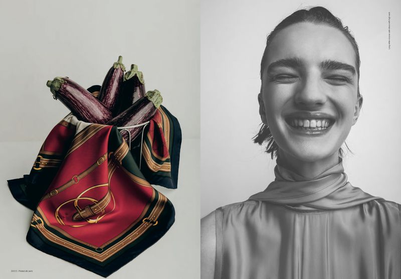 Black and white portrait of smiling woman juxtaposed with still life of eggplants in bowl with designer scarf in a white setting.