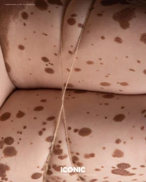 Extreme close-up of spotted skin bound with a thin crisscrossed twine string for Iconic Artist magazine.