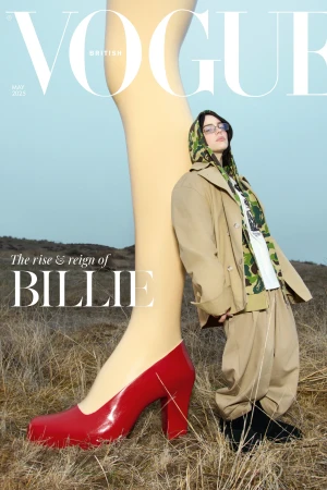 British Vogue cover features a stylish woman in a trench coat and hooded camo top next to a giant leg and red high heel.