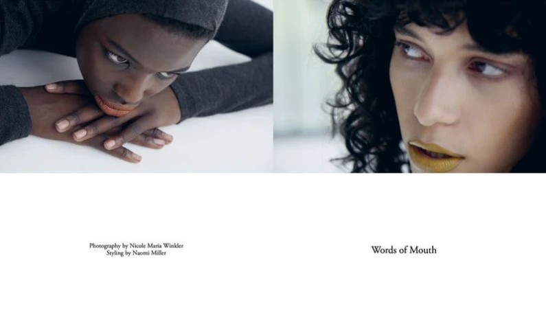 Two striking faces of fashion models, one with dark skin and a gray hood, the other with light skin and dark curly hair.