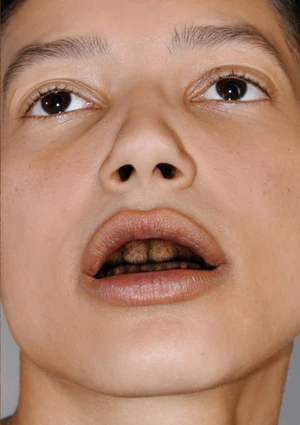 Extreme close-up portrait of a model looking upwards against a neutral background for Pull Letter Magazine