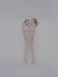 Two female models in pink bandeau tops and tights posed vertically against a plain white studio background.