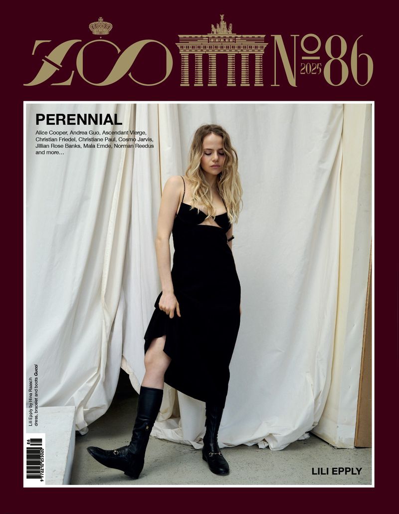 ZOO Magazine cover featuring Lili Epply in a black dress and boots, standing against a white draped background. The cover is maroon and gold.
