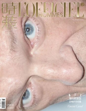 Close-up magazine cover featuring a man's face, showcasing his eyes and nose with the magazine's logo and text overlayed.