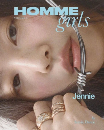 Fashion magazine cover featuring a close-up of Jennie's face and hand adorned with rings, styled with silver metal around her face.