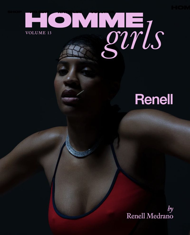 Portrait of Renell Medrano wearing a red top and silver necklace against a dark background for HommeGirls Volume 13