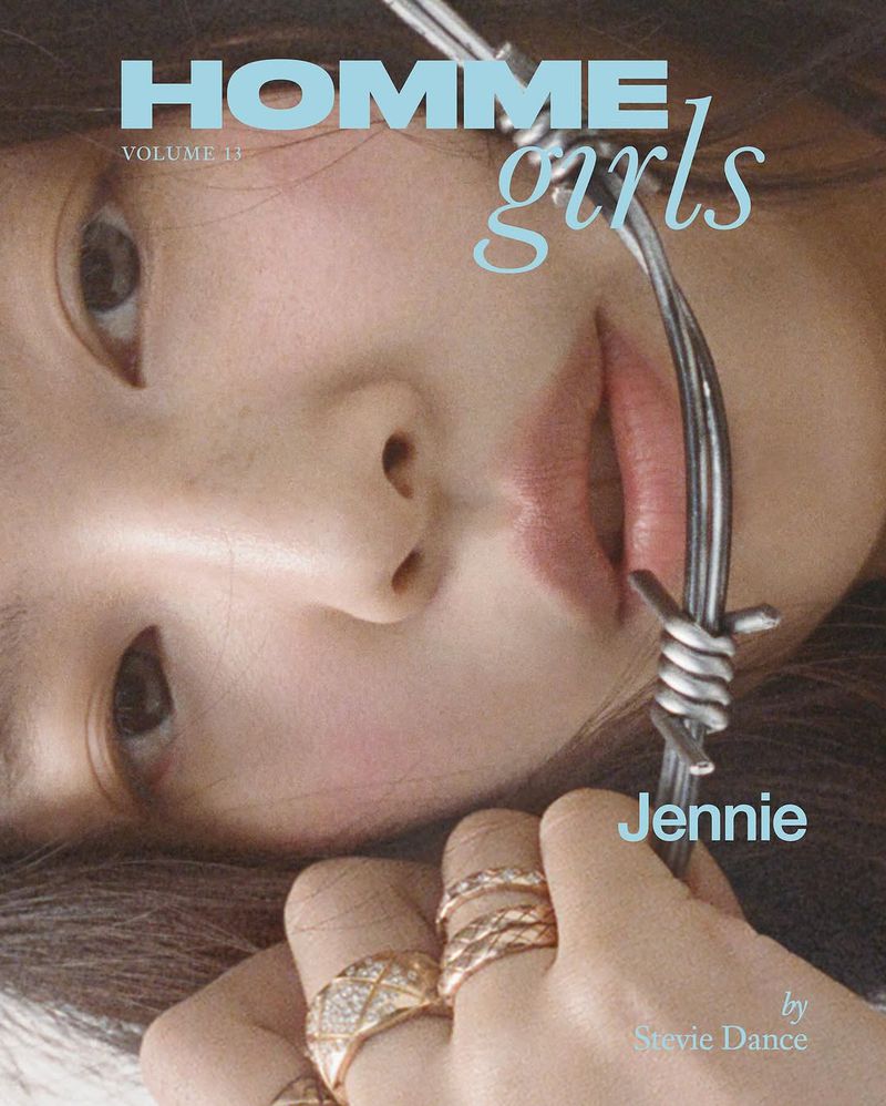Close-up editorial portrait of Jennie holding a piece of barbed wire near her face wearing rings for HommeGirls Volume 13.