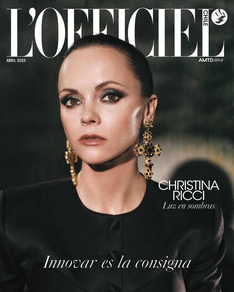 Magazine cover featuring Christina Ricci, showcasing her wearing gold cross earrings and a black jacket against a dark background.