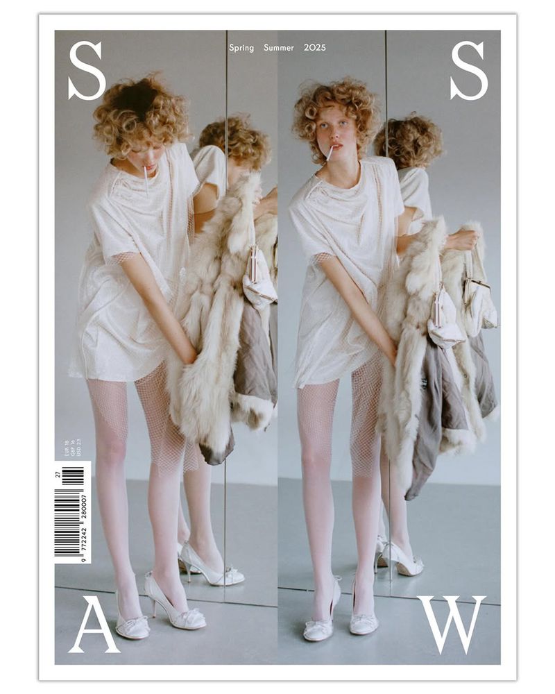 Magazine cover featuring a young woman in white, posing with a fur coat, stockings, and heels. The composition uses mirroring.