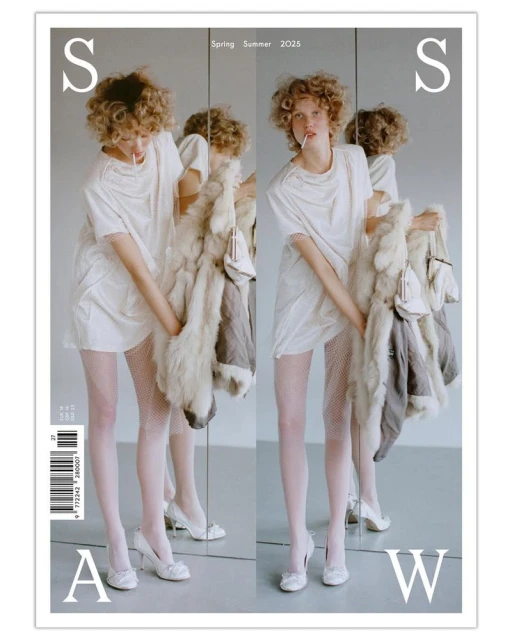 Magazine cover featuring a young woman in white, posing with a fur coat, stockings, and heels. The composition uses mirroring.