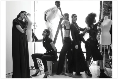 Black and white editorial fashion image featuring six models posing with mannequins in a studio setting